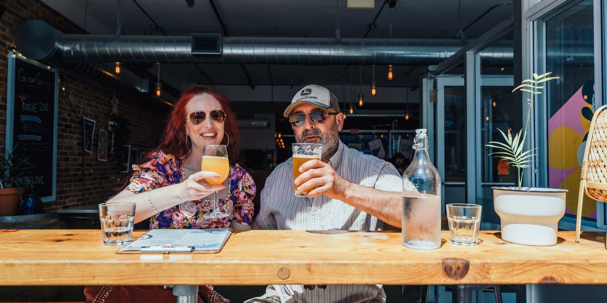 Couple enjoying craft beer at a bar in downtown Kingston.
