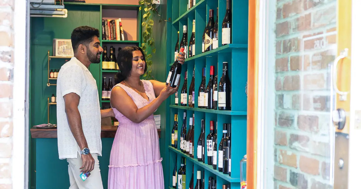 Shoppers browsing bottles of wine inside a local shop in downtown Kingston.
