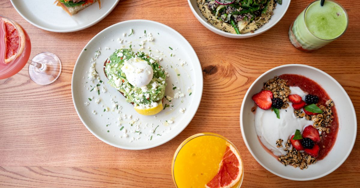 A variety of colorful dishes and beverages on a wooden table. at Northside espresso