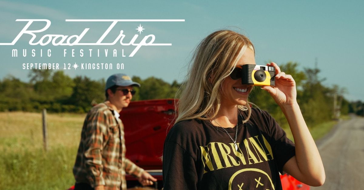 Woman taking a photo with a camera; man standing by a car.