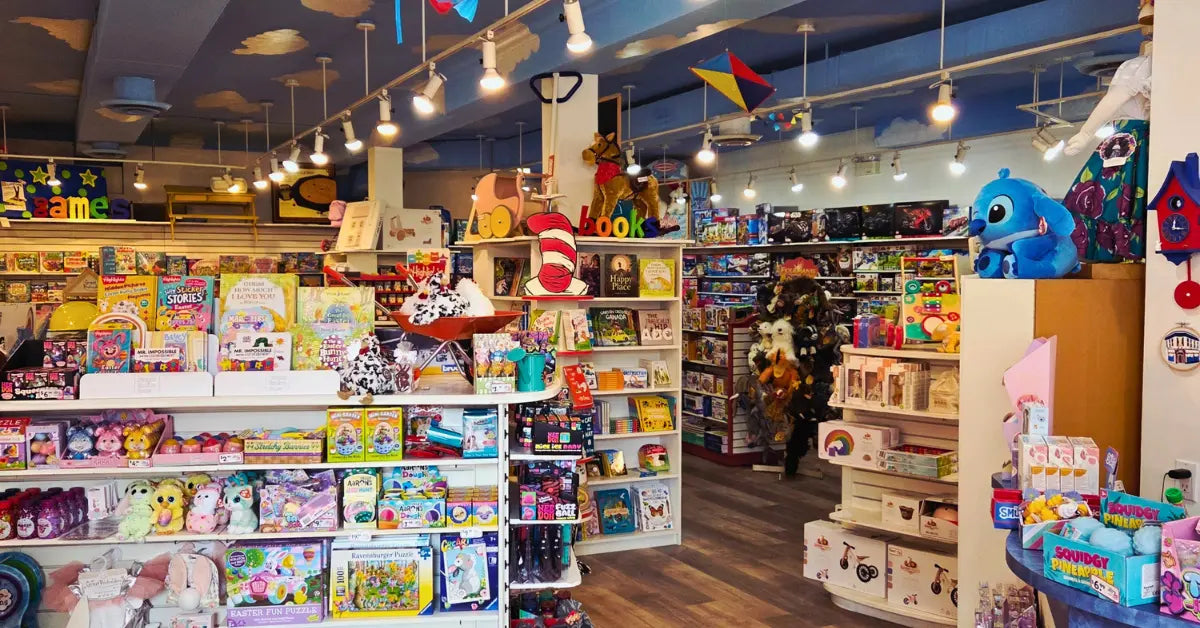 Colorful toy store interior filled with shelves of various games and plush toys.