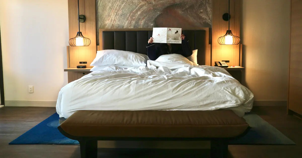 Cozy bedroom with a neatly made bed and bedside lamps.