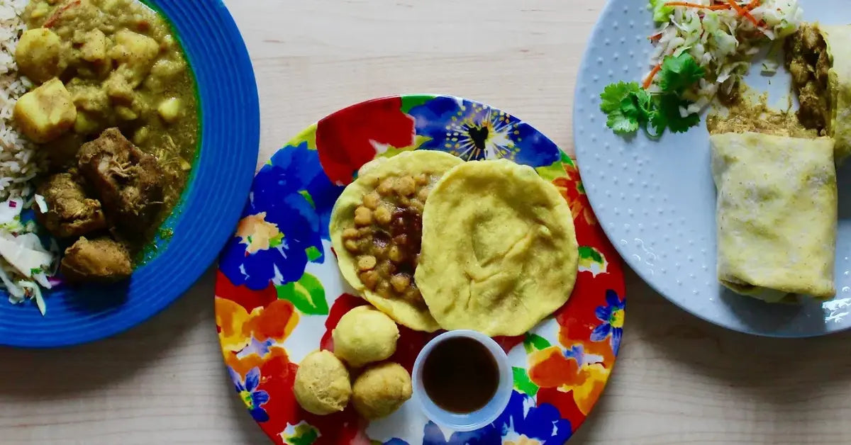 Three plates of assorted dishes from Sally's Roti Shop, including snacks and curries.